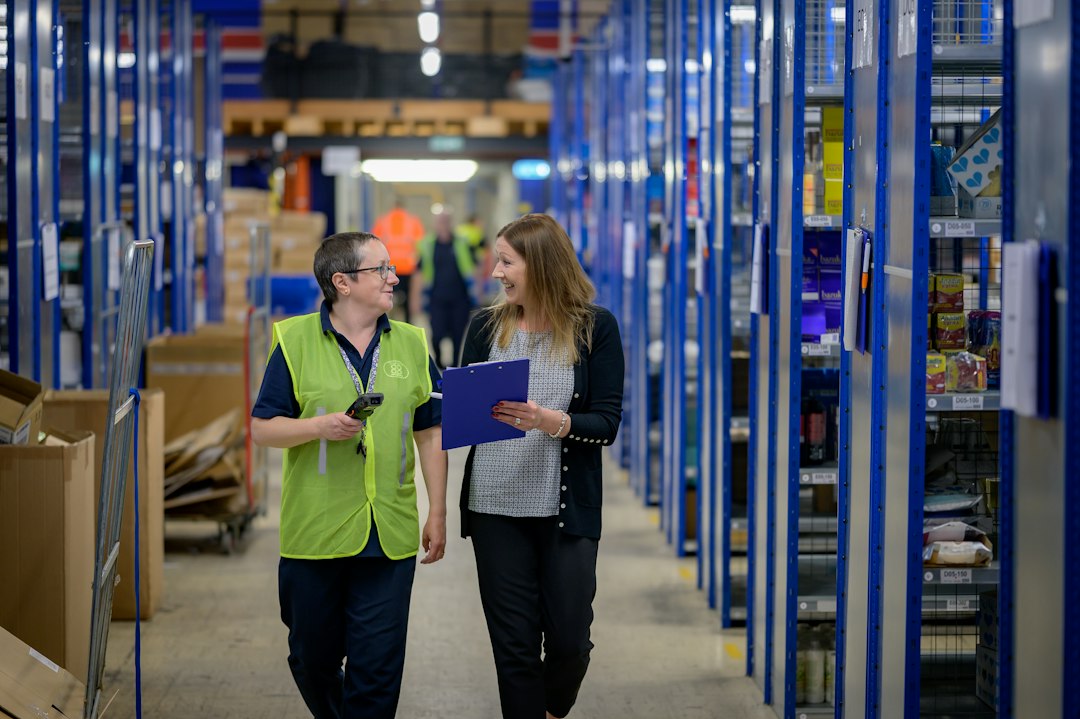 Two workers walking in a warehouse, illustrating the industrial setting for Digit 5 safety
